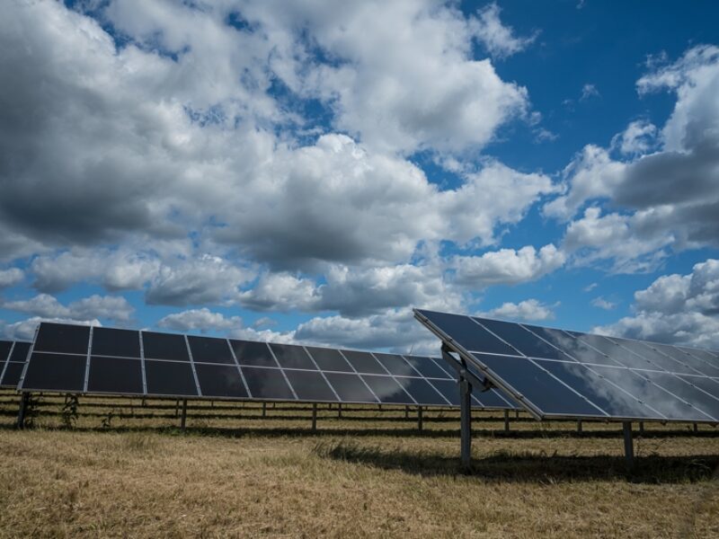 Solar panels used for renewable energy on the field under the sky full of clouds