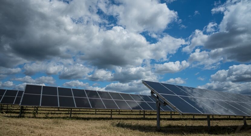 Solar panels used for renewable energy on the field under the sky full of clouds